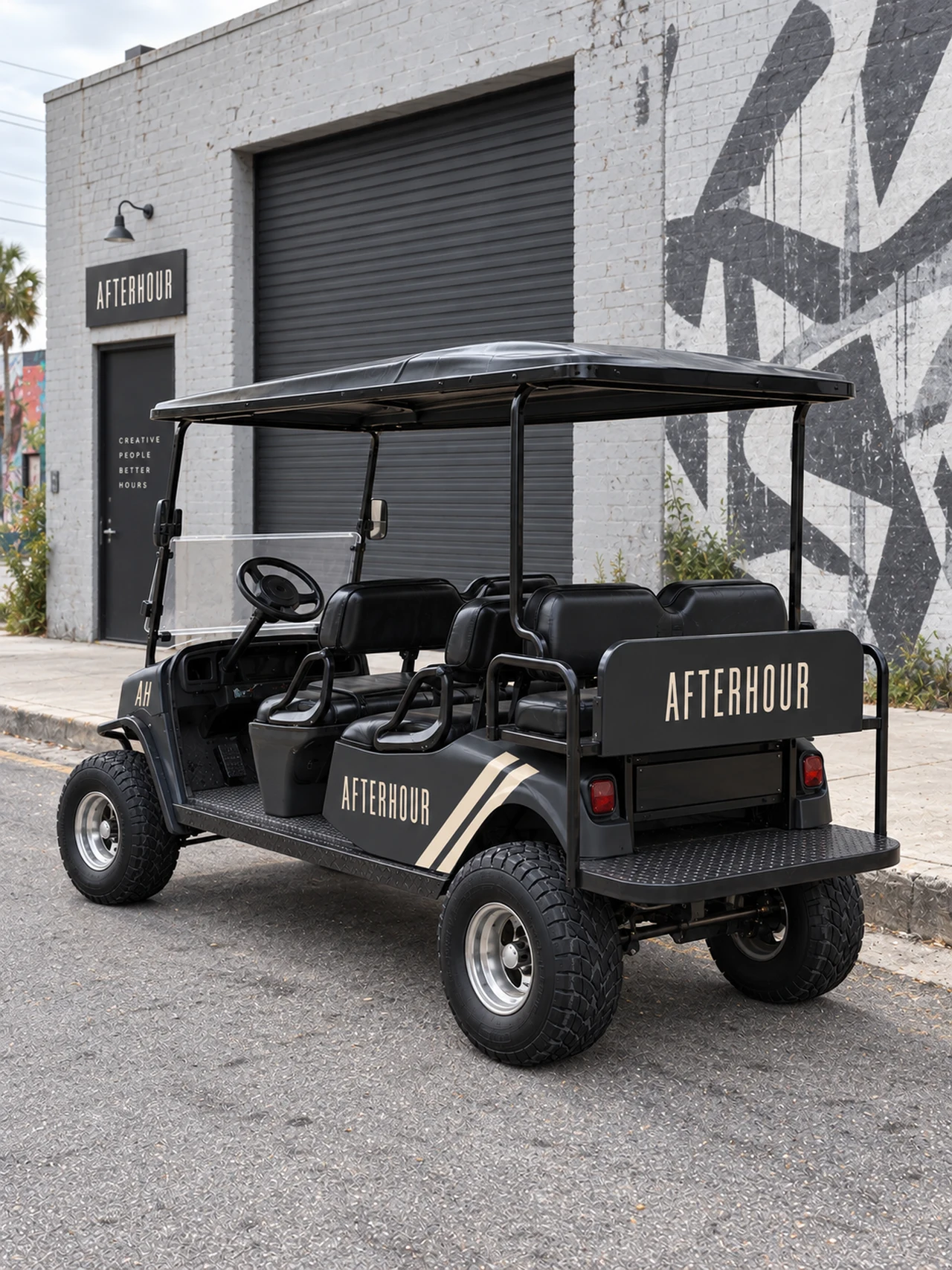 AI-generated AFTERHOUR wrap concept, rear three-quarter view outside a creative warehouse